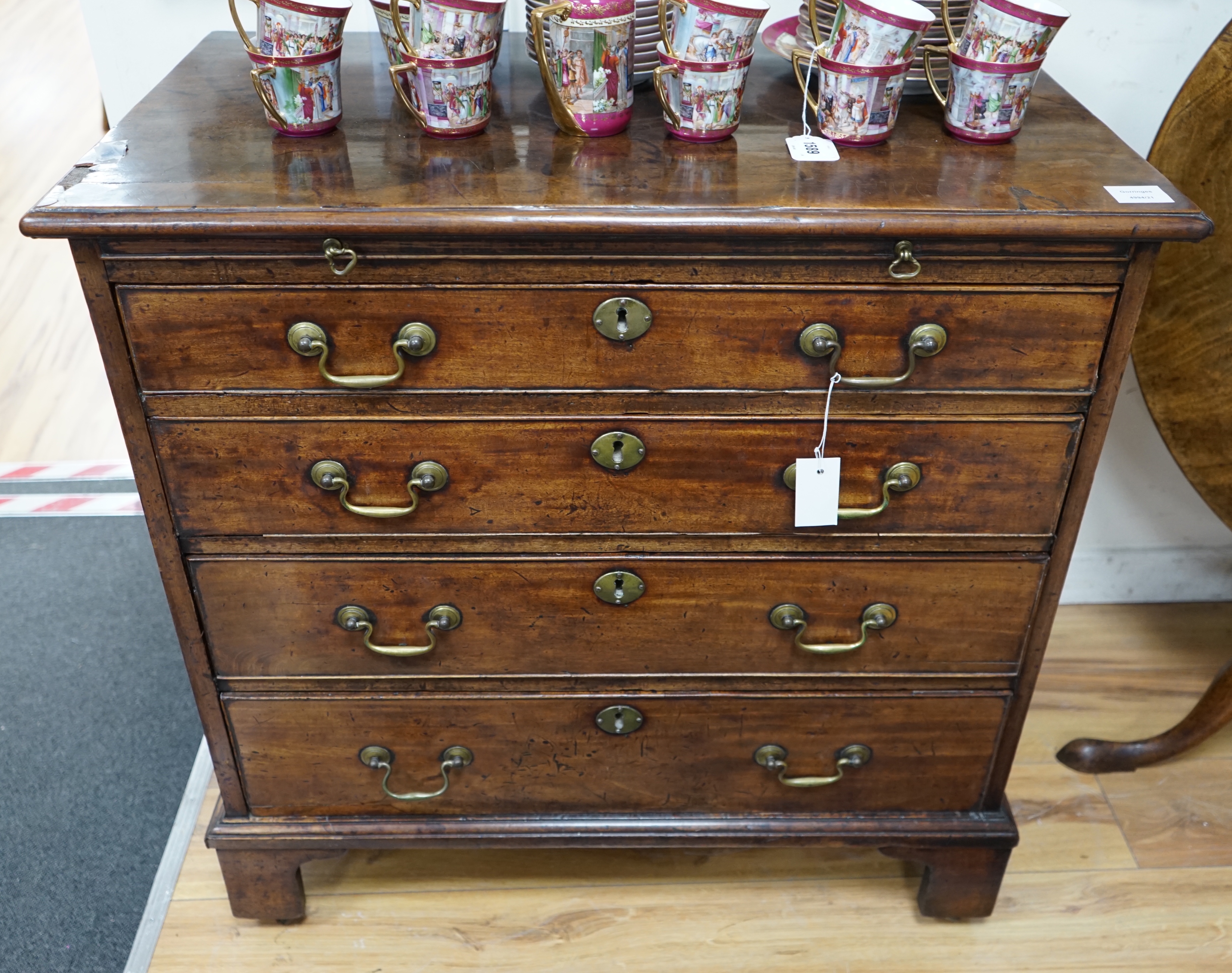 A George III mahogany chest of four graduating long drawers with brushing slide and brass handles, width 85cm depth 49cm height 84cm